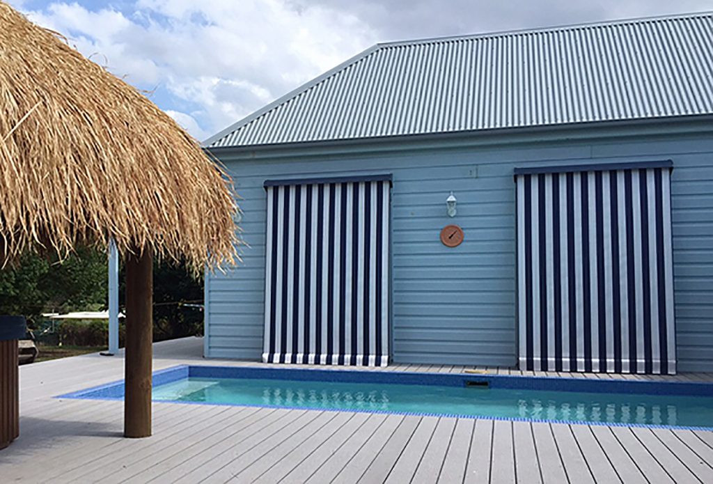 Striped Automatic Awning by BlindMan - Bali hut Poolside